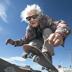 Gartenposter An elderly woman, a grandmother with glasses and gray hair, does a trick on a skateboard. Active lifestyle of the elderly © Саша Григорьева