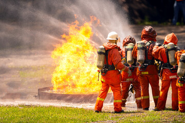 firefighter train fireman team extinguish spraying fire gas explosion. Fire fighter learning stop...