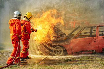 firefighter training fireman team use extinguish spraying fire car. Fire fighter learning stop fire...