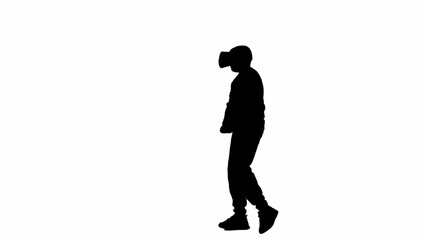 Fototapeta na wymiar Portrait of kid boy isolated on white background with alpha channel. Silhouette of schoolboy wearing virtual reality glasses and walking.