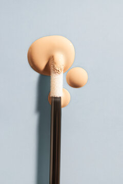 Cosmetic liquid concealer swatch drops with brush applicator
