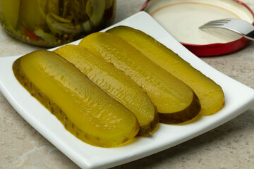 Plate with sliced pickled gherkins close up