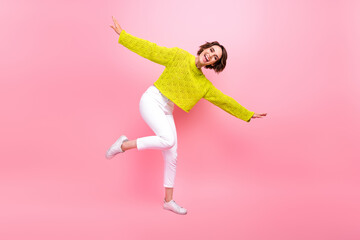 Full length photo of carefree charming girl dressed neon sweater dancing having fun isolated pink color background