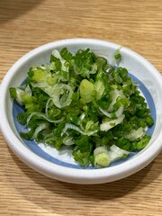 Green springs onion with wooden background