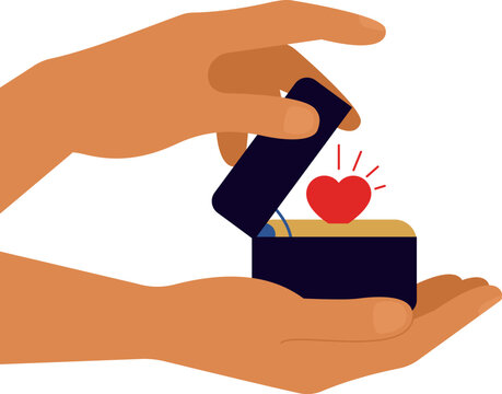 Male hands hold opened black box for jewelry or wedding ring with shiny heart shape inside. Abstract luxury package for love heart. Concept of proposal and sharing love.