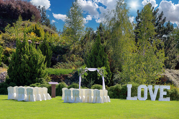 Outdoor wedding ceremony site in a green glade on a beautiful sunny day - 689727665