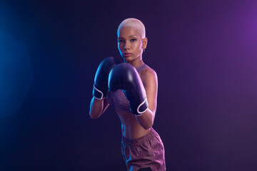 The Boxing. Brazilian woman boxer. Sportsman muay thai boxer fighting in gloves. Isolated on black background. Copy Space.