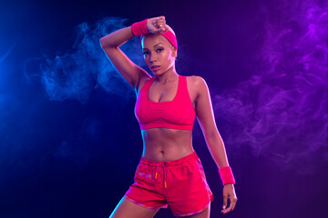 Sporty fit woman, athlete after fitness exercises on black background. Download cover for music collection for fitness classes. Sports recreation. Beautiful black young woman.