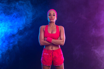 Sporty fit woman, athlete after fitness exercises on black background. Download cover for music collection for fitness classes. Sports recreation. Beautiful black young woman.