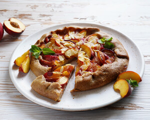 peach pie on a plate, light background, close-up without people