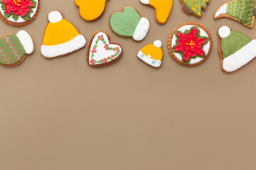 Christmas delicious gingerbread cookies on a brown background. Top view. Space for text.