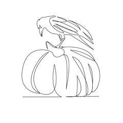 raven sitting on a pumpkin