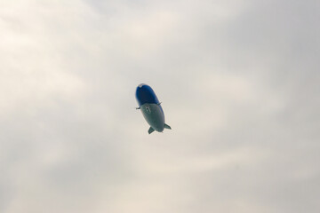 Blimp, airship or dirigible flying in sky