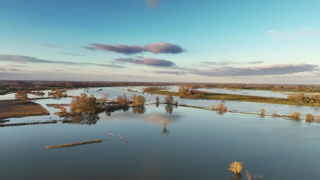 IJssel river flood near Zwolle and Zalk with water running over the floodplains during flooding caused by high water levels after heavy rain.