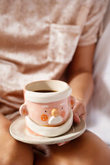 Cropped woman drinking tea. Cozy winter time background.