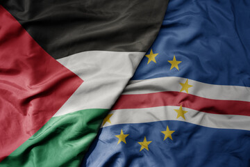 big waving national colorful flag of cape verde and national flag of palestine .