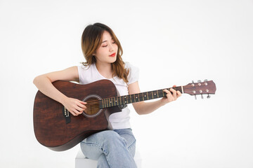 Asian teenager woman playing guitar song isolated white background