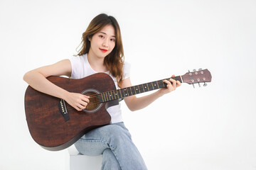 Asian teenager woman playing guitar song  eye looking at camera isolated white background
