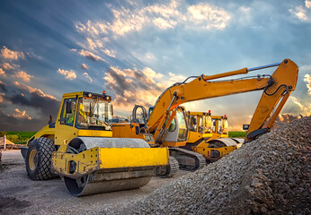 Parked drum roller and excavators at the construction site, after work - obrazy, fototapety, plakaty
