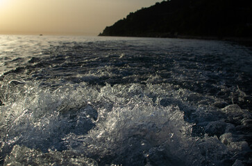 Splashes of water from under a motor boat