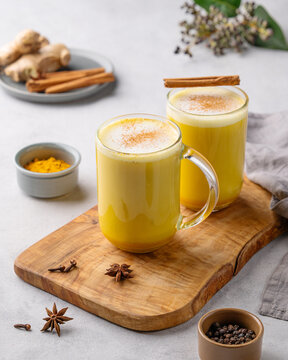 Turmeric golden milk latte with spices and honey. Detox, immunity boosting, anti-inflammatory, healthy, cozy drink