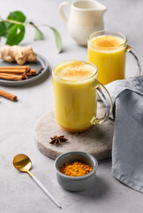 Turmeric golden milk latte with spices and honey. Detox, immunity boosting, anti-inflammatory, healthy, cozy drink - obrazy, fototapety, plakaty