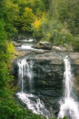 Blackwater Falls of West Virginia in full autumn color with river cascading over granite boulders