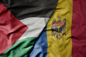 big waving national colorful flag of moldova and national flag of palestine .