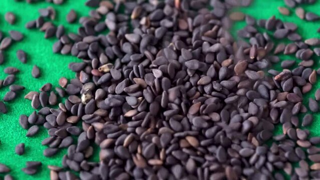 black sesame seeds on green background