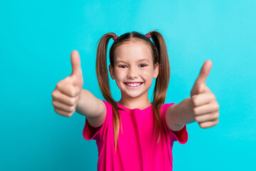 Photo of adorable cheerful preteen age girl wear stylish pink clothes share feedback good job thumbs up isolated on cyan color background