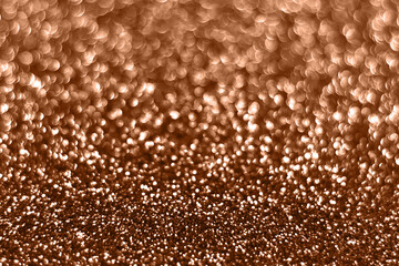 Peach fuzz sparkling glitter bokeh background, abstract defocused texture. Holiday lights