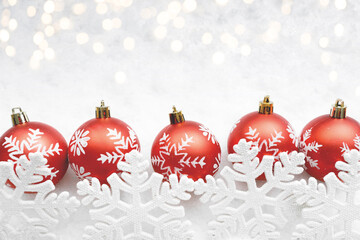 Christmas red balls decorated snowflakes on snow background