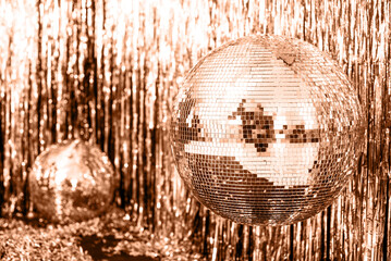 color of the year. Peach Fuzz. Festive gold background. disco ball on beige and Set Sail Champagne...