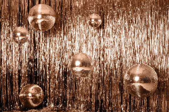 color of the year. Peach Fuzz. Festive background. disco ball on beige and silver background. Christmas. Wedding. Birthday