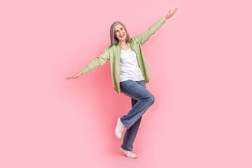 Photo of optimistic cheerful woman wear trendy clothes have fun fly air rejoice holiday vacation isolated on pink color background