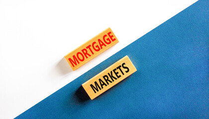 Mortgage markets symbol. Concept words Mortgage markets on beautiful wooden blocks. Beautiful white and blue background. Business mortgage markets concept. Copy space.