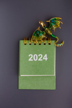 new year calendar and green dragon on a light background
