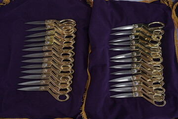 Gold scissors on a tray that will be used for the opening procession