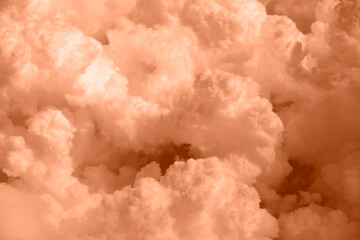 Banner. Color of the year 2024, Peachy Fuzz. Fluffy Cloudy sky background, dark clouds for rainy...