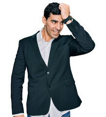 Handsome hispanic man wearing business clothes smiling confident touching hair with hand up gesture, posing attractive and fashionable