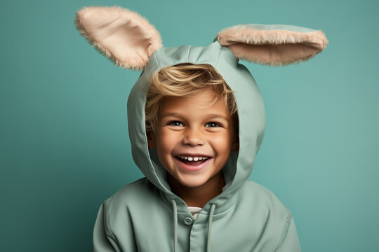 Naklejki Cheerful laughing child boy in a funny costume with bunny ears, Easter holiday concept