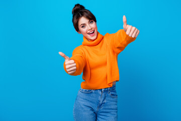 Photo of positive good mood lady wear knitted pullover showing you two thumbs up isolated blue color background - obrazy, fototapety, plakaty