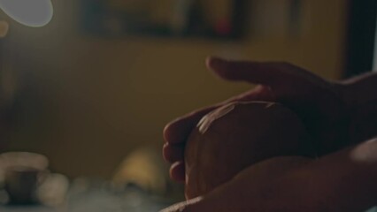 Human hands kneading wet clay. Small business at home studio. Artisan potter preparing material for creation. Sculptor artist arms beating clay for pottery