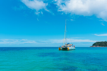 Sailing yacht in the sea. Sailboat in the sea under sunlight, luxury summer adventure, outdoor activities at sea. Sailboat sailing on ocean..