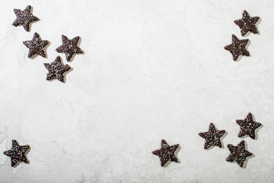 Chocolate star cookies on white surface