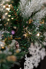 Christmas blurred background, pine branch with snow and beautiful white shiny bokeh. New Years. Airy atmosphere.