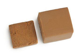 Brown cheese. Norwegian brunost isolated on white background. Top view. Flat lay