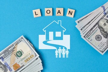 Loan wording on wooden tiles and US dollar banknotes and  house and family icons on blue background.Concept of mortgage loan, home loan for building a house. - obrazy, fototapety, plakaty