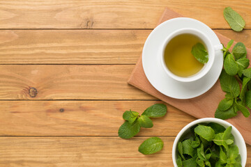 Fototapeta na wymiar Fresh mint tea on wooden background,top view