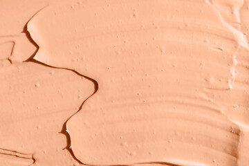 Peach color cosmetic, paint or clay texture close-up, abstract background